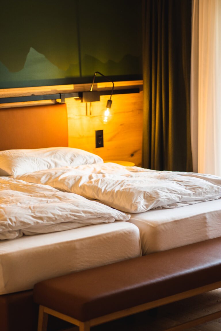 Morning light across a made bed
